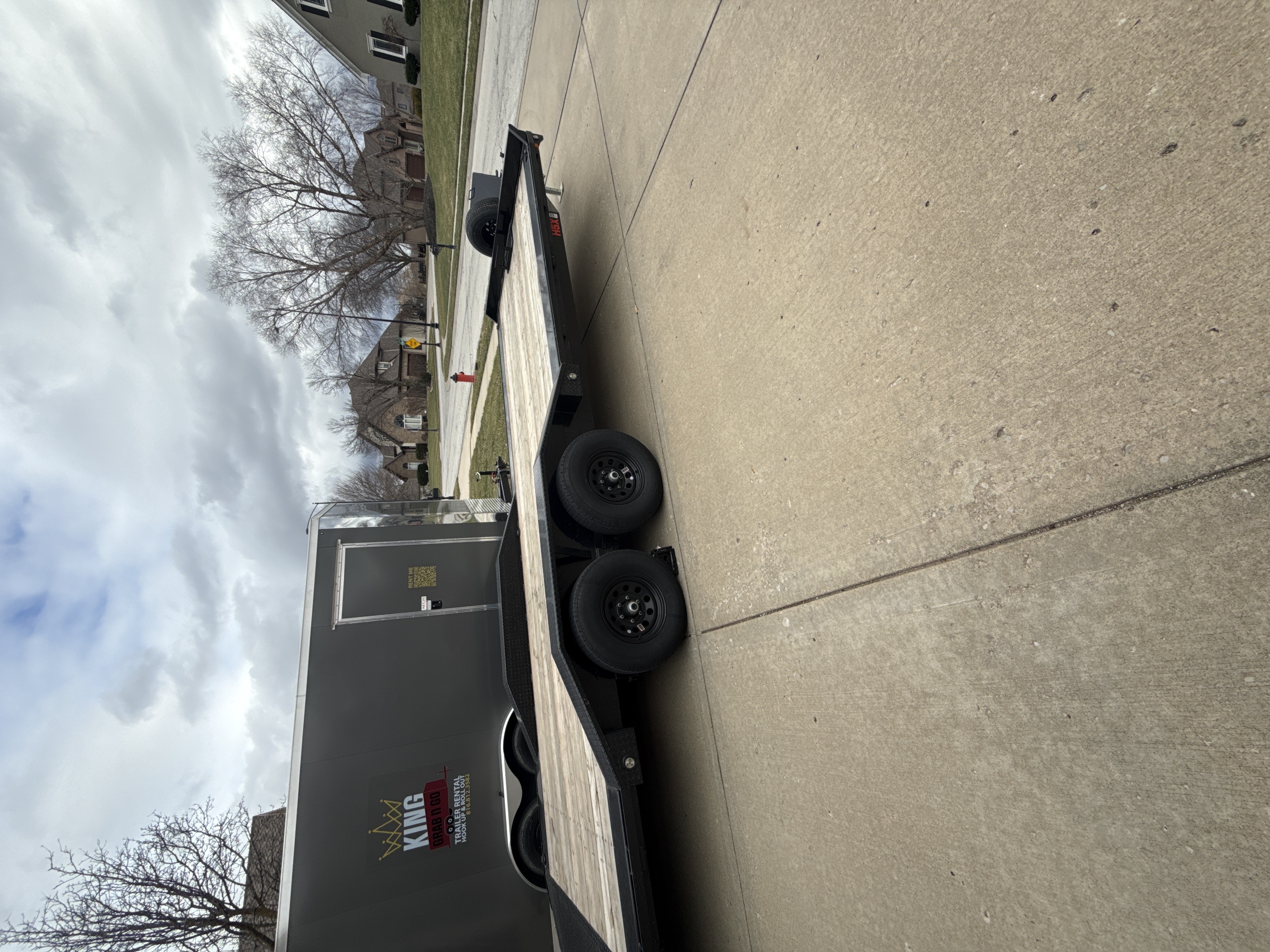 22ft flatbed car hauler trailer parked with King Grab N Go branding visible