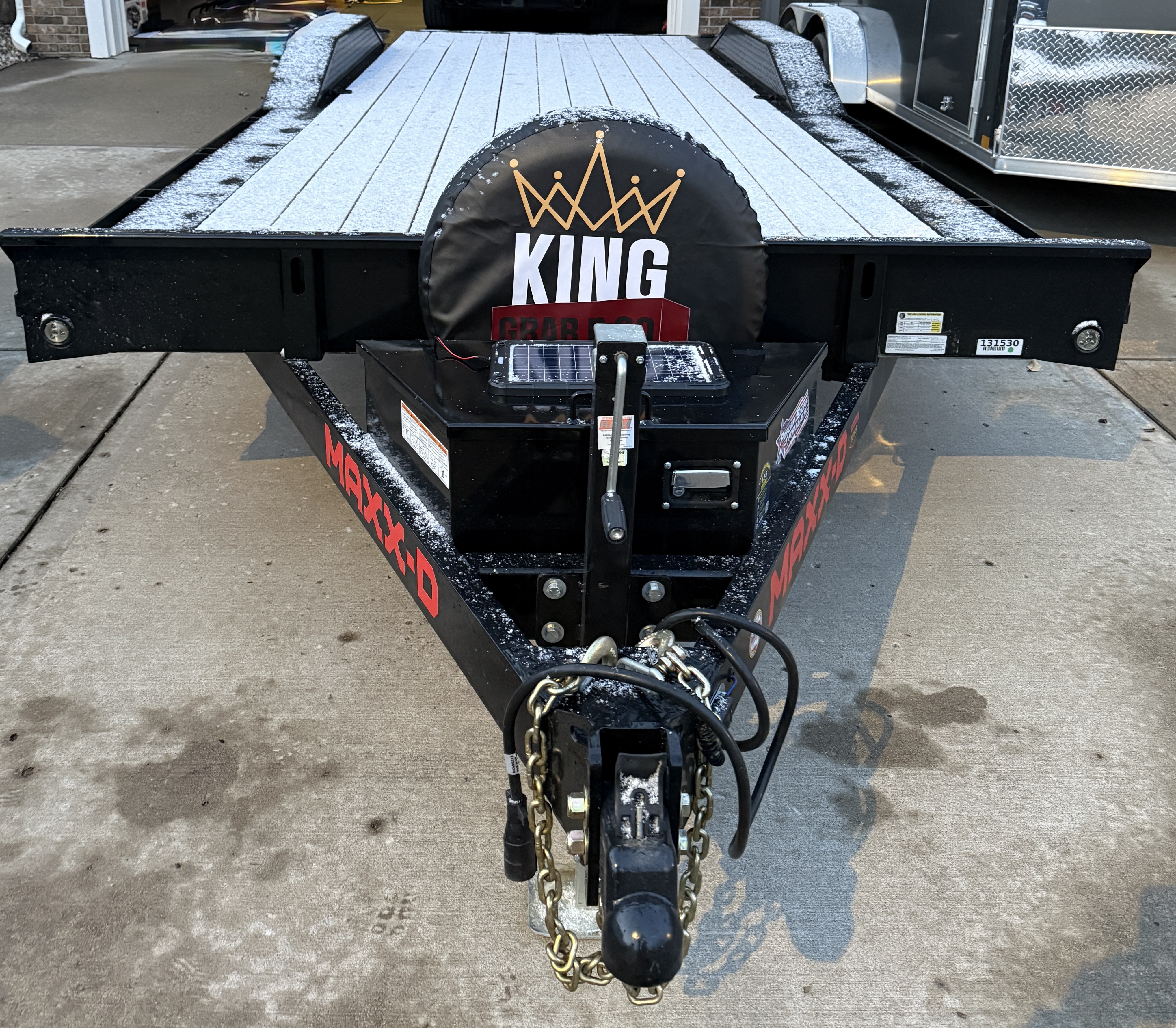 Rear view of car hauler trailer with King Grab N Go logo and branding on spare tire cover